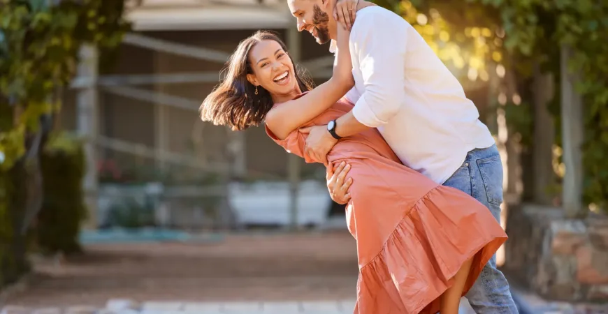 Happy couple, dance and love in park, garden and sunshine for bonding, quality time and romantic da.